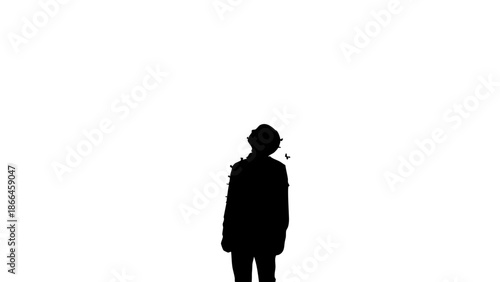 Silhouette of a person standing alone against the background. The person is a dark shape in contrast to the illuminated surrounding