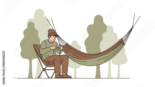 Man Assembling Hammock For Camping Adventure In Forest For Nature Relaxation