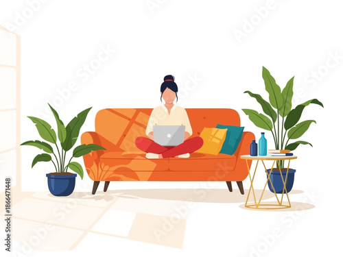 Woman sitting on couch working on laptop with plants