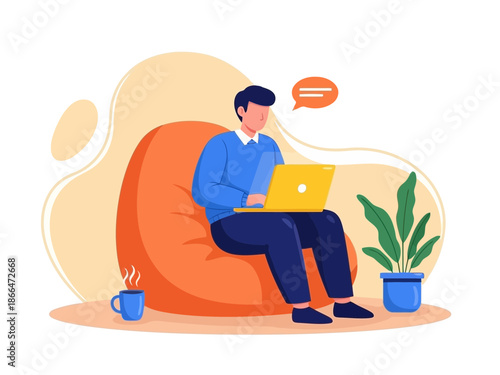 Man sitting on bean bag chair working on laptop with plant and cup of coffee nearby at home