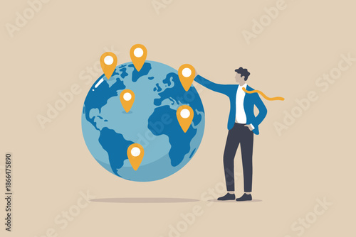 A businessman standing next to a globe with location pins, representing global business expansion