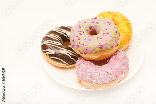 Sweet donuts on a plate. A delicious sweet snack. An American doughnut.
