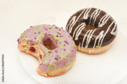Sweet donuts on a plate. A delicious sweet snack. An American doughnut.