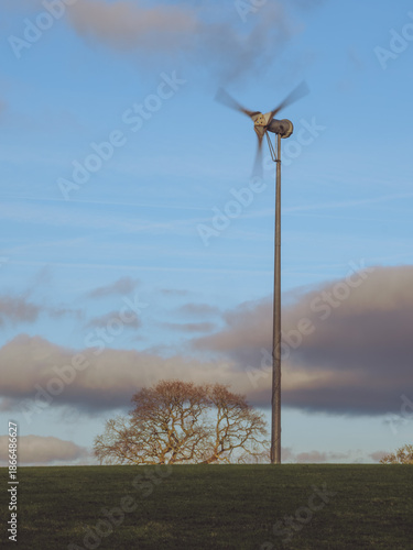 A small wind turbine in a field used on a farm