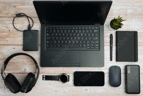 Wallpaper Mural Flat lay business workspace with laptop, smartphone, headphones, mouse, notebook, watch, and accessories on white wooden desk representing productivity, and digital professional lifestyle. Torontodigital.ca