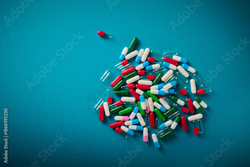 Colorful pills on a blue table