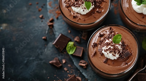 Decadent Chocolate Mousse Dessert with Whipped Cream and Chocolate Shavings on Dark Stone Background.