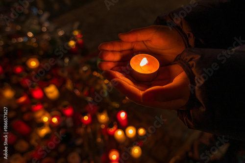 Hands Holding Candle in Warm Light During Night