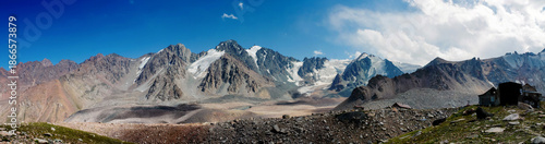 Tuyuk Su Valley mountain landscape in Kazakhstan with snow capped peaks, rocky slopes, and glacial terrain near Almaty. High altitude environment showing Central Asian mountains, alpine geology, outdo