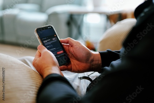 Middle Aged Man Gets Mobile Phone Notification of Suspicious Foreign Banking Transactions - FinTech Cybersecurity Mobile Banking Alerts Concept