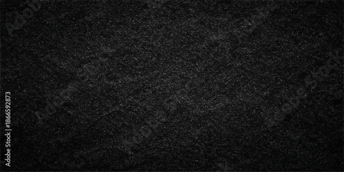 A dark textured background featuring a blend of rough black leather and cloth fabric material creates a blank grunge textile wallpaper with a grey macro pattern surface design