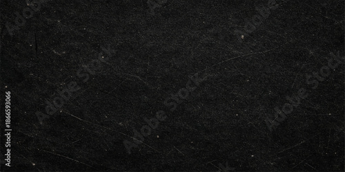 A dark grunge background featuring a black and white snow pattern with a rough textured surface that resembles old grey paper or weathered fabric material for a macro wall backdrop design