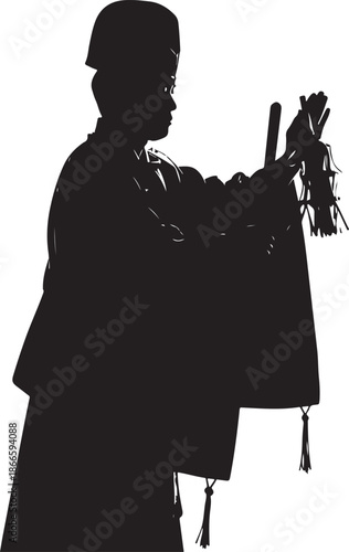 A musician playing bagpipes captured in a striking black silhouette