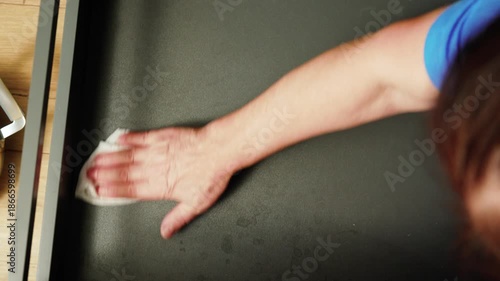 Organizing kitchen drawer with dividers in a home setting during afternoon hours