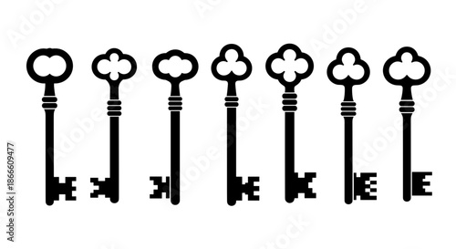 Set of vintage keys with ornate handles and different sizes on a plain background