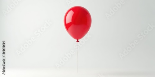 Classic red balloon in mid-air; clean white backdrop , sphere, studio, round