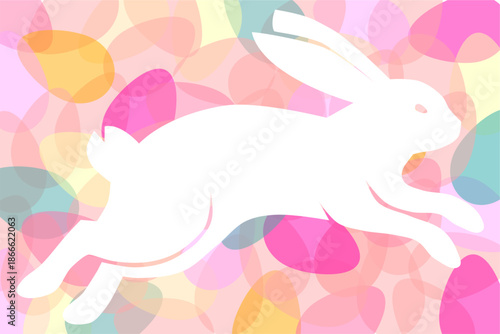 Dynamic white silhouette of a jumping or running rabbit over a background of colorful Easter eggs.