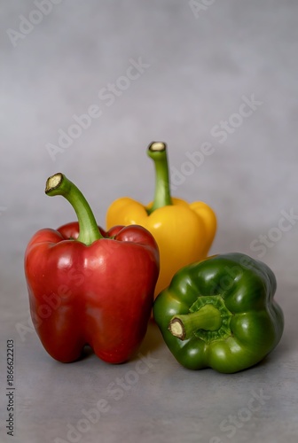 Vibrant and Fresh Bell Peppers in a Colorful Trio - Red, Yellow, and Green Sweet Peppers Ready for Healthy Cooking and Culinary Creations