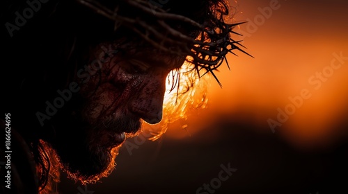 A dramatic depiction of Jesus Christ wearing a crown of thorns at sunset