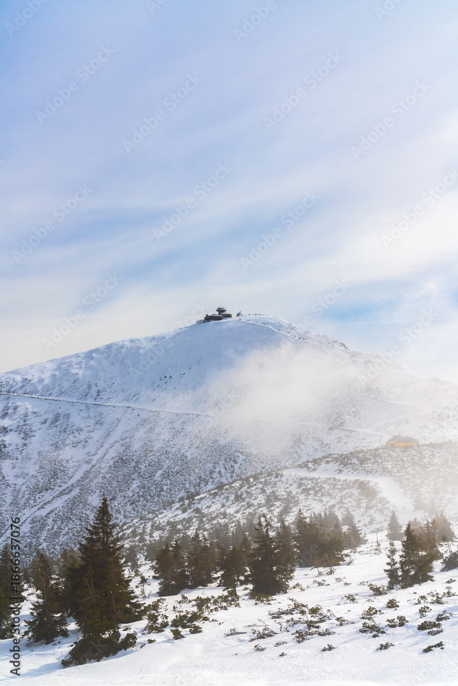 Fototapeta premium Highest mountain is Snezhka, snowy mountain landscape in winter in Poland. Winter nature, travel destination, and outdoor scenery concept.