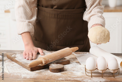 Woman kneading fresh dough ...