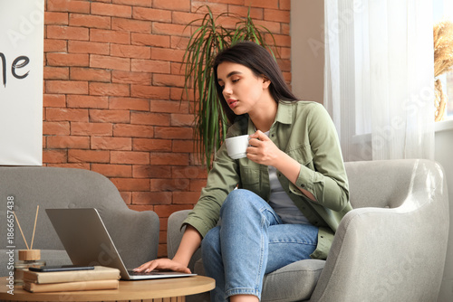 Female freelancer with cup ...
