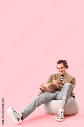 Young man reading book on p...