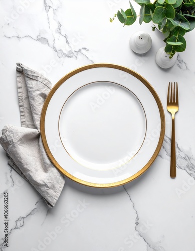 Elegant White Plate With Gold Rim And Golden Fork Set On A Marble Tablecloth With Grey Napkin And Greenery Accents