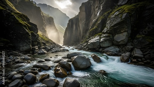 Crystal clear river flowing through a dramatic rocky canyon surrounded by steep cliffs and misty mountains