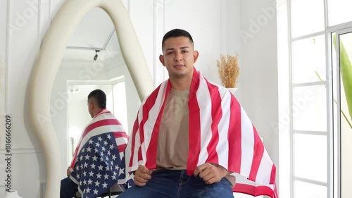 young man with the US flag hanging on his back