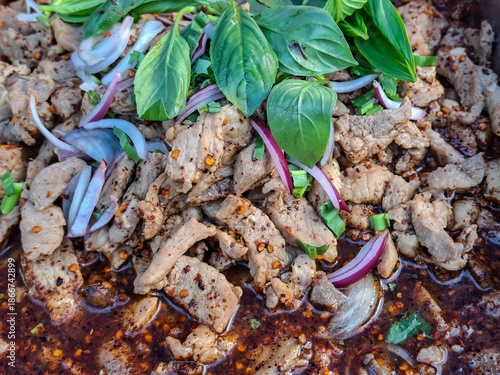 Pork is seasoned with a spicy chili powder that appears to contain Thai herbs,Thai Spicy minced pork salad.