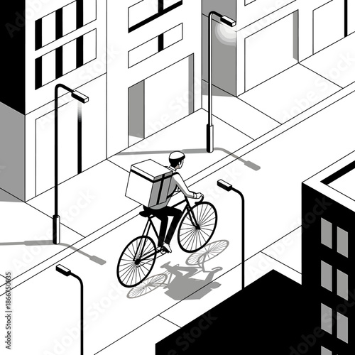 A cyclist rides a bicycle down a city street with buildings and streetlights around.