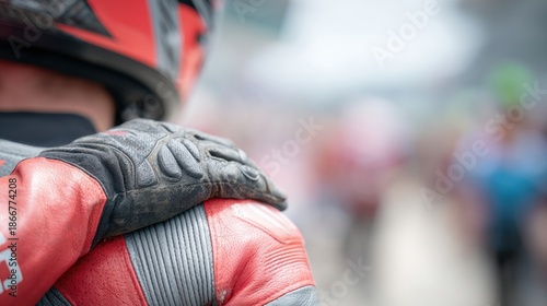 A Close-Up of a Motorcyclist Wearing Red and Black Gear, Emphasizing the Grit of Riding and the Bond Among Racing Enthusiasts