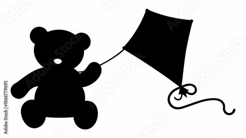 Black teddy bear flying kite in playful pose