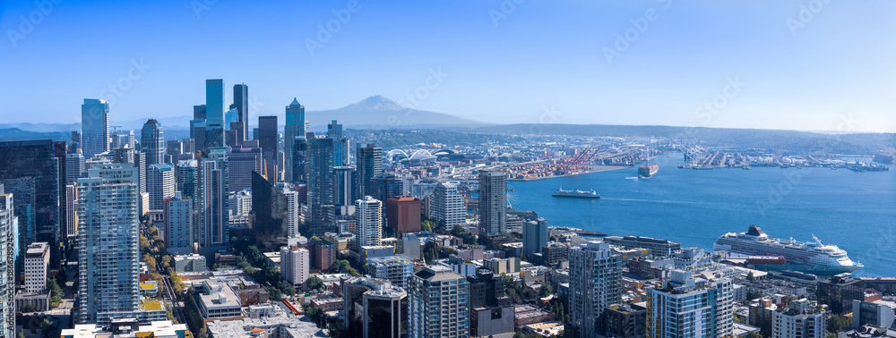 Fototapeta premium Panoramic Seattle financial district skyline in city downtown with Mount Rainier in the background.
