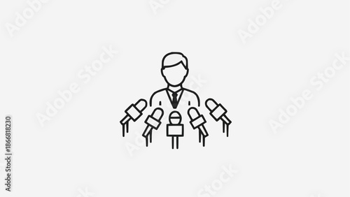 Man speaking at a press conference with multiple microphones.