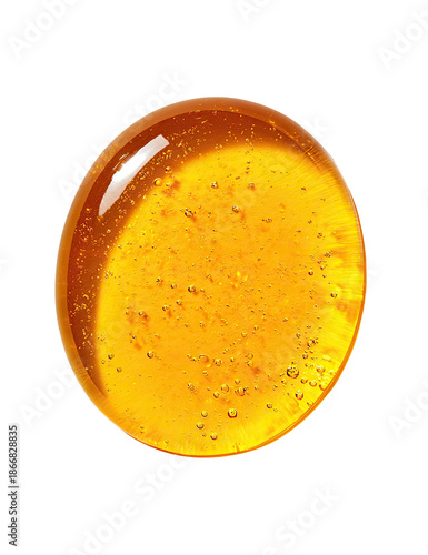 Golden orb liquid droplet, transparent with tiny bubbles, isolated on black