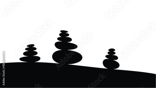 Balanced stacked stones symbolize harmony and tranquility in a serene landscape.