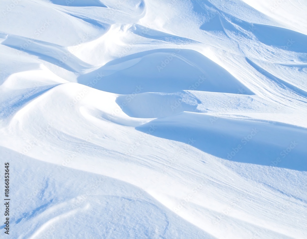 Fototapeta premium Soft white snow drifts under a cool blue sky, texture and light
