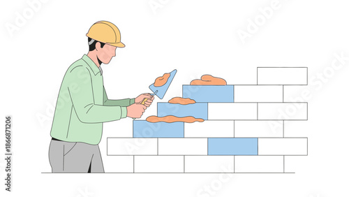 Construction worker applying mortar to bricks on a wall