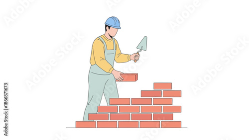 Construction worker laying bricks with a trowel on a building site