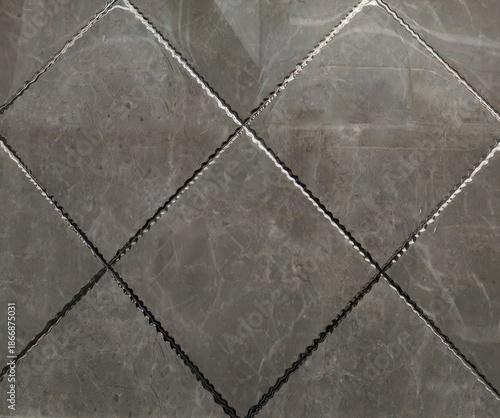 Dark gray marble tiles with diamond pattern and grout lines