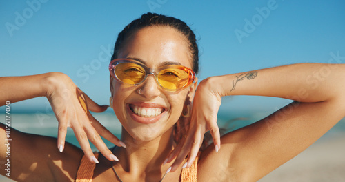 Photos Woman, excited and sunglasses on beach for travel, sun protection and hand frame on vacation