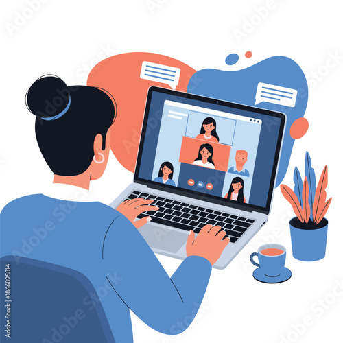 Woman from behind works on a laptop while participating in a remote video conference with several colleagues displayed on the screen.