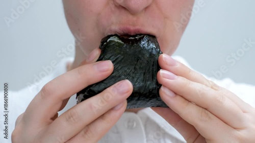 Female hand holding korean samgak close-up on gray background