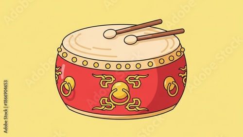 A vibrant red and gold drum with intricate designs and two drumsticks on top, set against a bright yellow background.