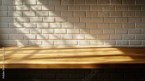 Light-drenched wooden tabletop against a white brick wall