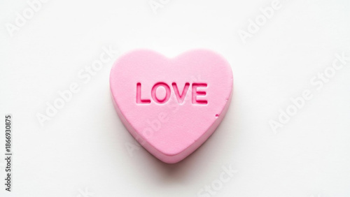 Pink heart-shaped candy with love text on white background, Valentine's Day sweet, romantic confection, conversation heart
