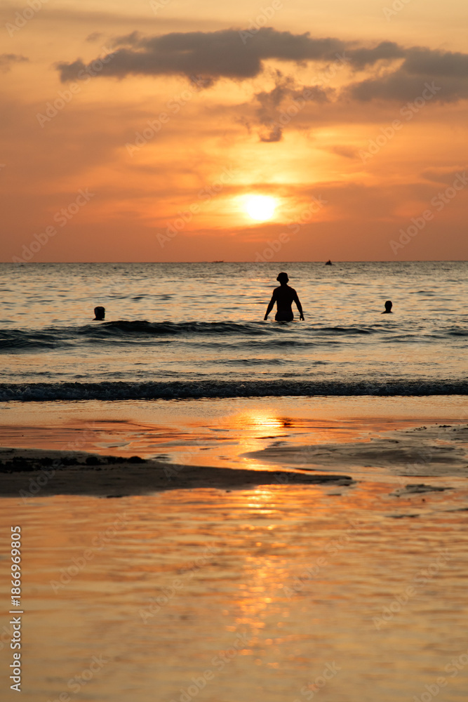 Fototapeta premium A man is swimming in the ocean