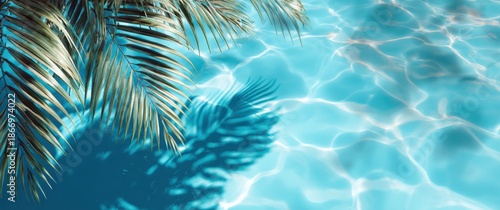 Blurred palm leaf shadows on a blue water background, a summer banner template with copy space for text